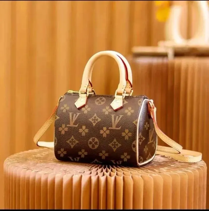 Bruine Louis Vuitton-handtas met monogram, handgreep en crèmekleurige afwerking