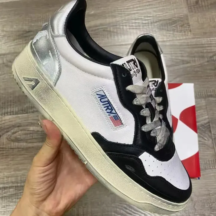 Autry Low-Top Sneakers in White, Black, and Silver