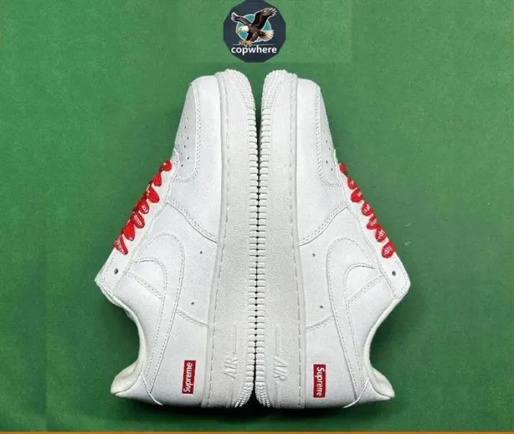 Supreme White Low-Top Sneakers with Red Laces